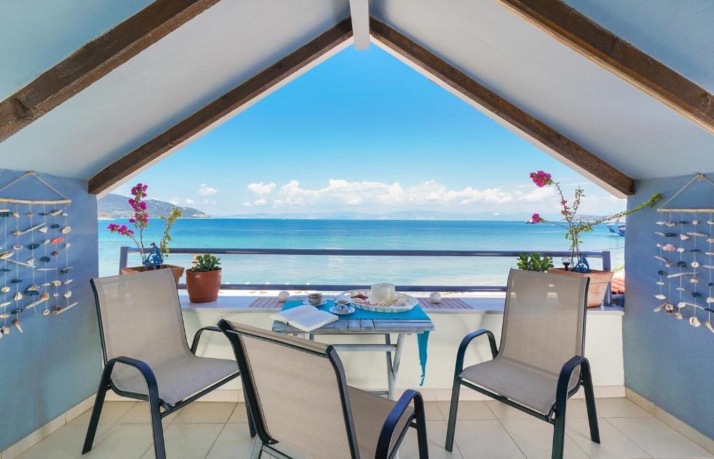 a dining room with a view of the ocean at Lina's Sea View Apartments in Limenas
