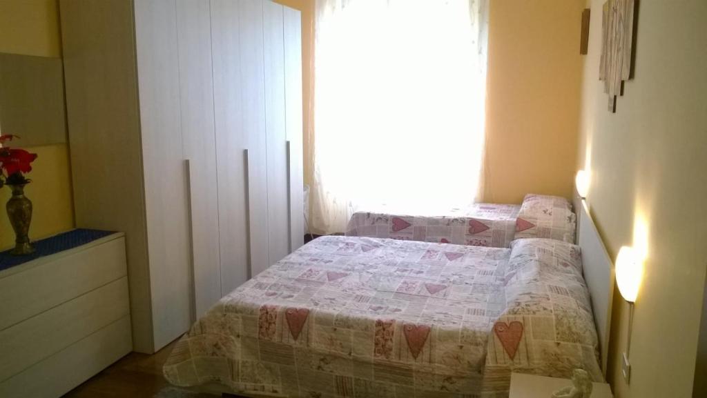 a small bedroom with a bed and a window at Il Sole di Ostia in Lido di Ostia