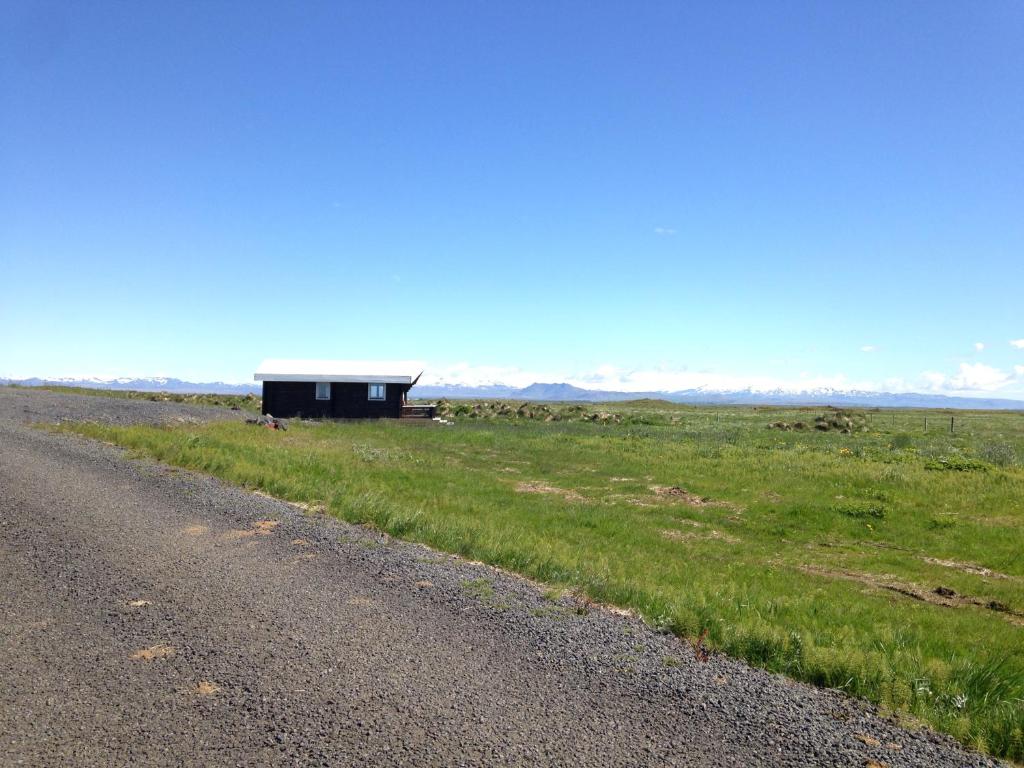 a small building sitting on the side of a road at Midholl guesthouse in Ásmundarstaðir