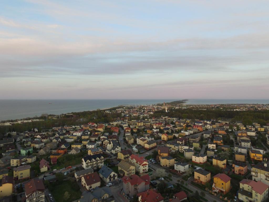 an aerial view of a city with houses and the ocean at Orle Gniazdo in Władysławowo