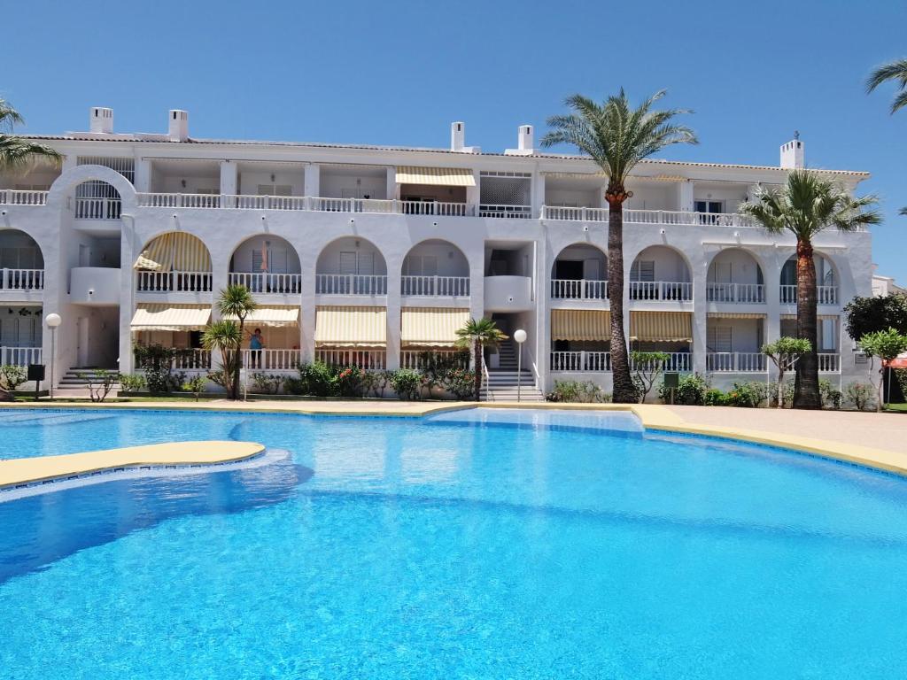 uma grande piscina em frente a um edifício em RODERIC - Apartamento junto al Mar em Oliva