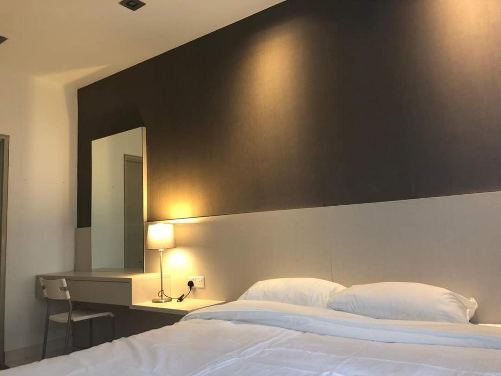 a bedroom with a large white bed and a mirror at Setia Walk Puchong in Puchong
