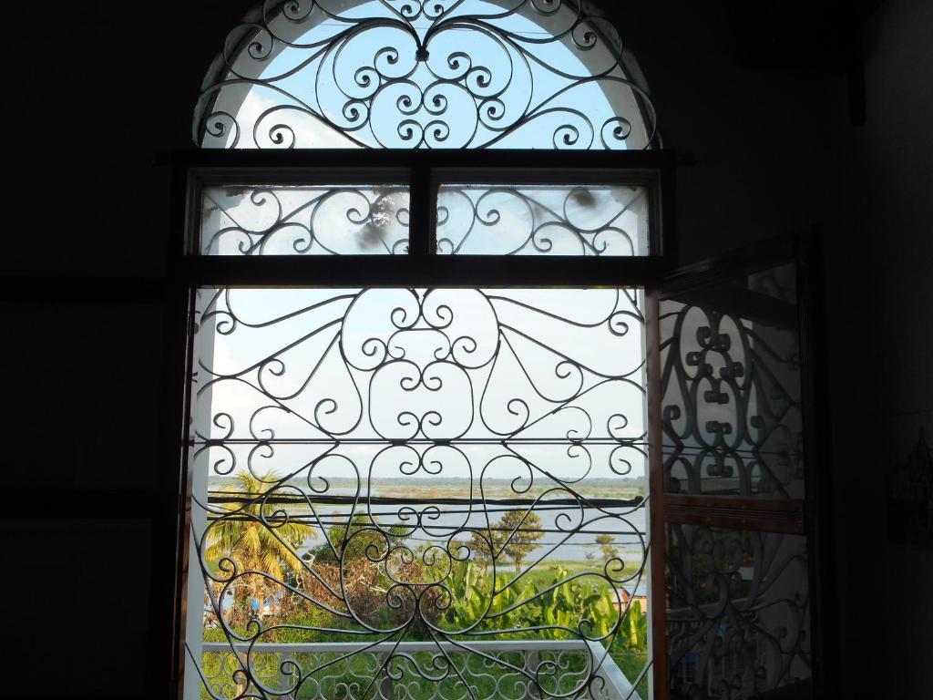 a window with a view of a garden at Epoca Iquitos in Iquitos