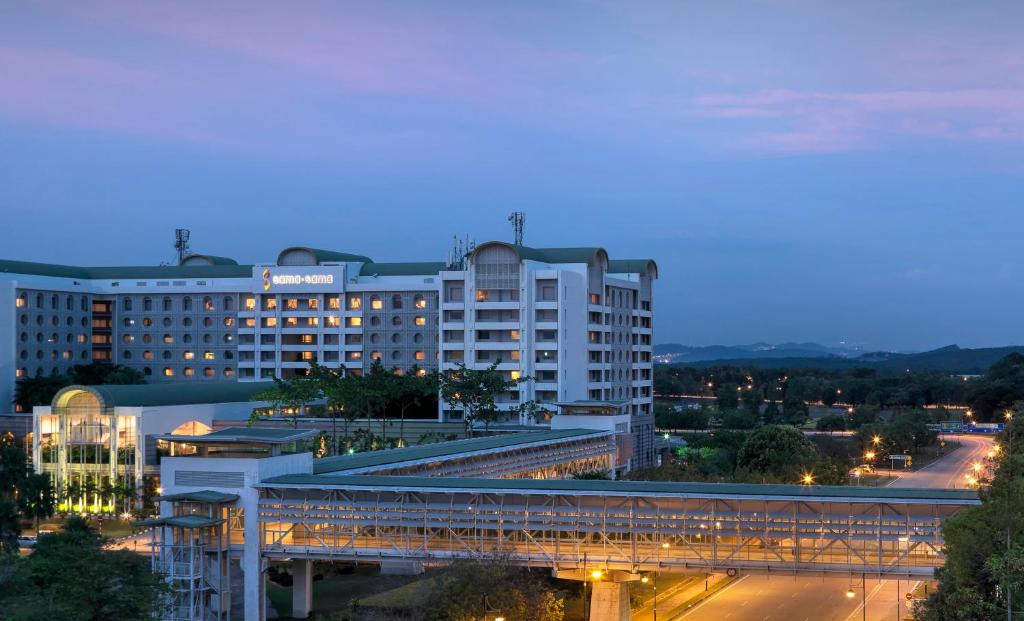 a large building with a bridge over a street at Sama Sama Hotel KLIA in Sepang