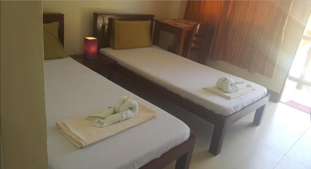 Letto o letti in una camera di SLAM'S Garden Dive Resort