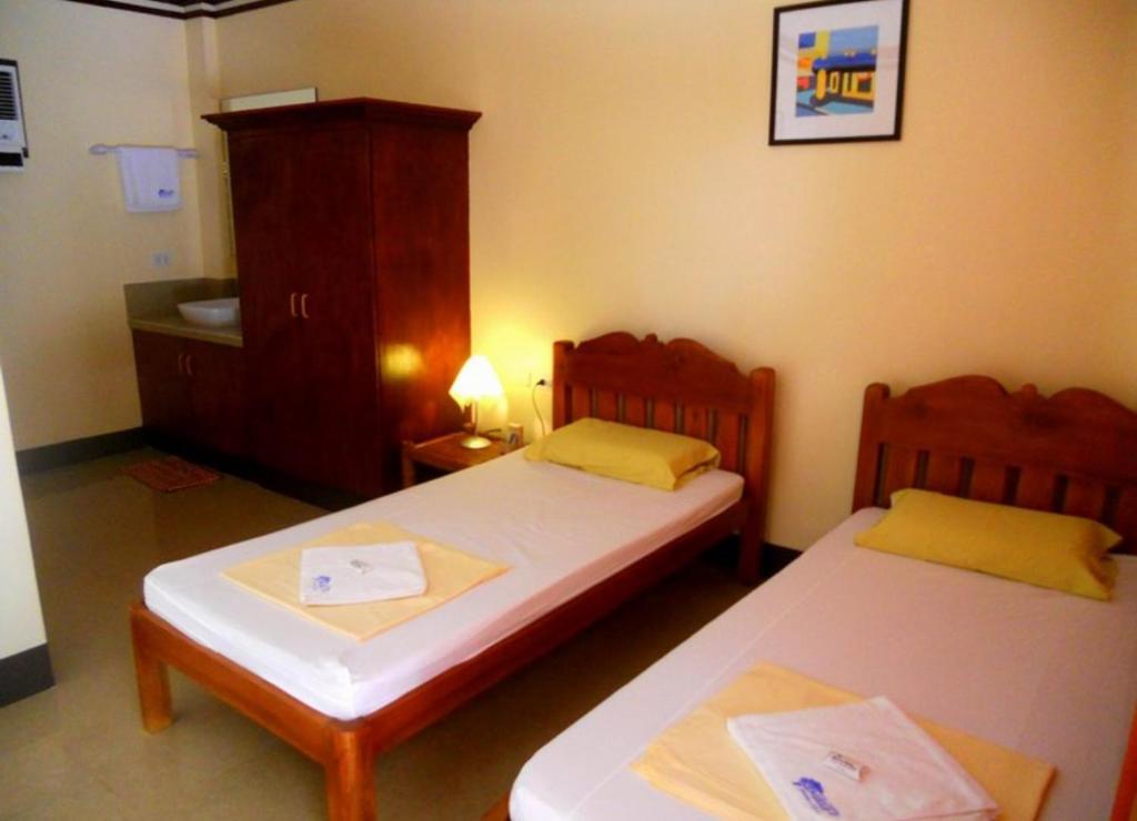 Letto o letti in una camera di SLAM'S Garden Dive Resort