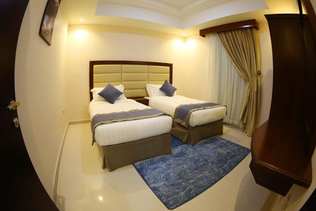 Postel nebo postele na pokoji v ubytování SAS Al Olaya Hotel Suites