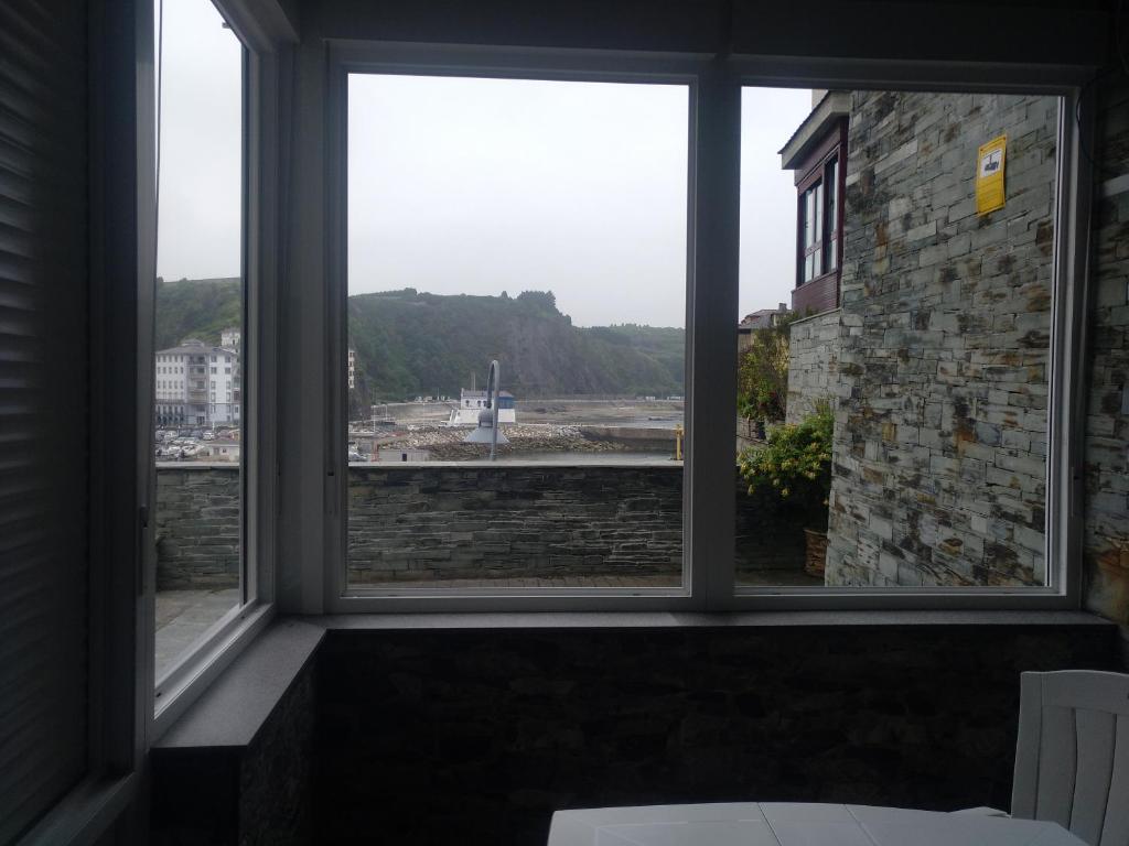 a large window with a view of a building at Apartamentos turísticos Vistademar in Luarca