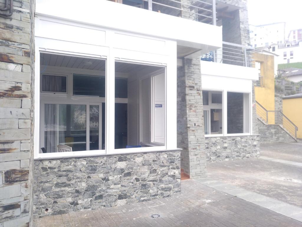 a window on a building with a stone wall at Apartamentos turísticos Vistademar in Luarca