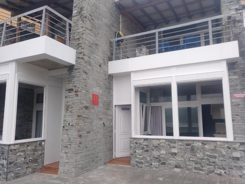 a facade of a building with two windows at Apartamentos turísticos Vistademar in Luarca