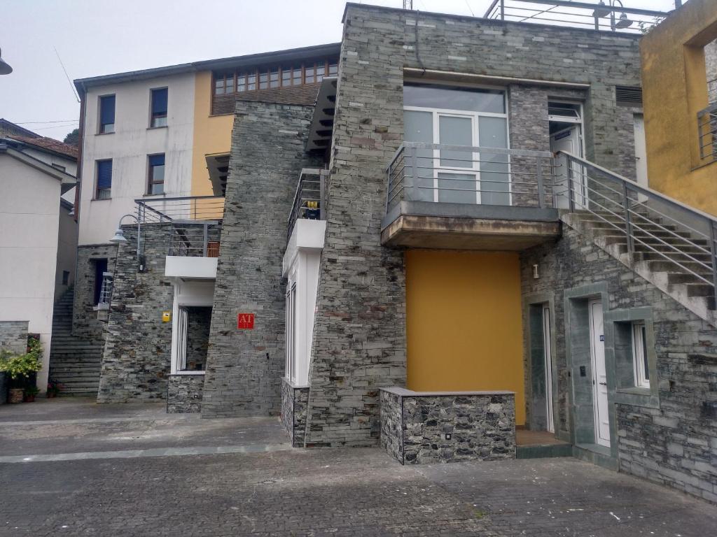 a brick building with a staircase on the side of it at Apartamentos turísticos Vistademar in Luarca