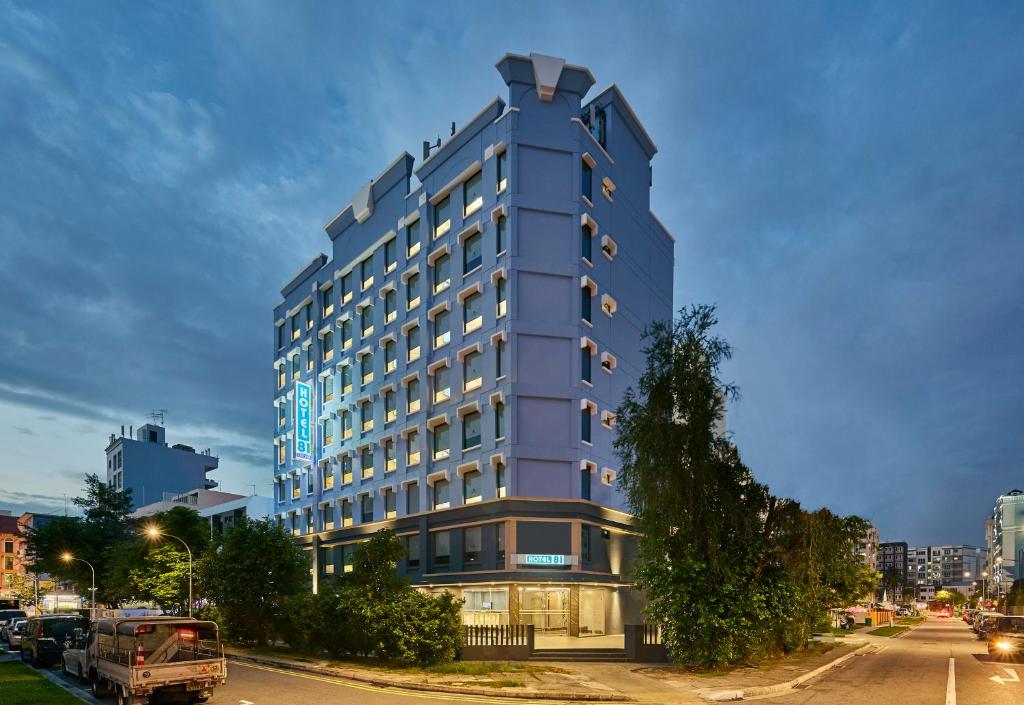 a tall blue building on a city street at Hotel 81 Orchid in Singapore