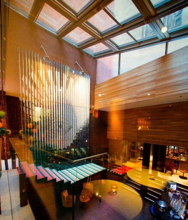 a lobby with a glass table in a building at Hotel Klaus K in Helsinki