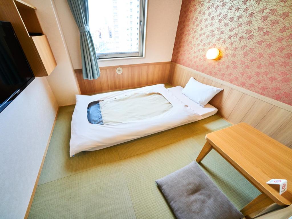 Krevet ili kreveti u jedinici u okviru objekta Super Hotel Matsuyama