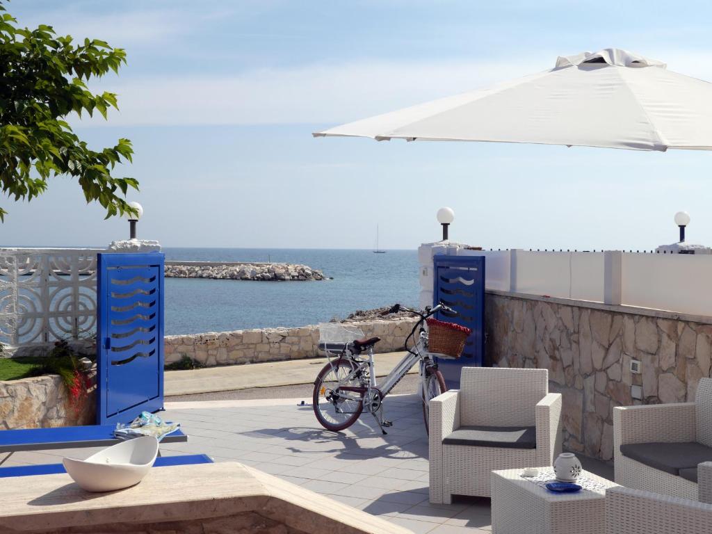 a bike parked on a patio next to the ocean at Pietra di Luna a...mare in Polignano a Mare