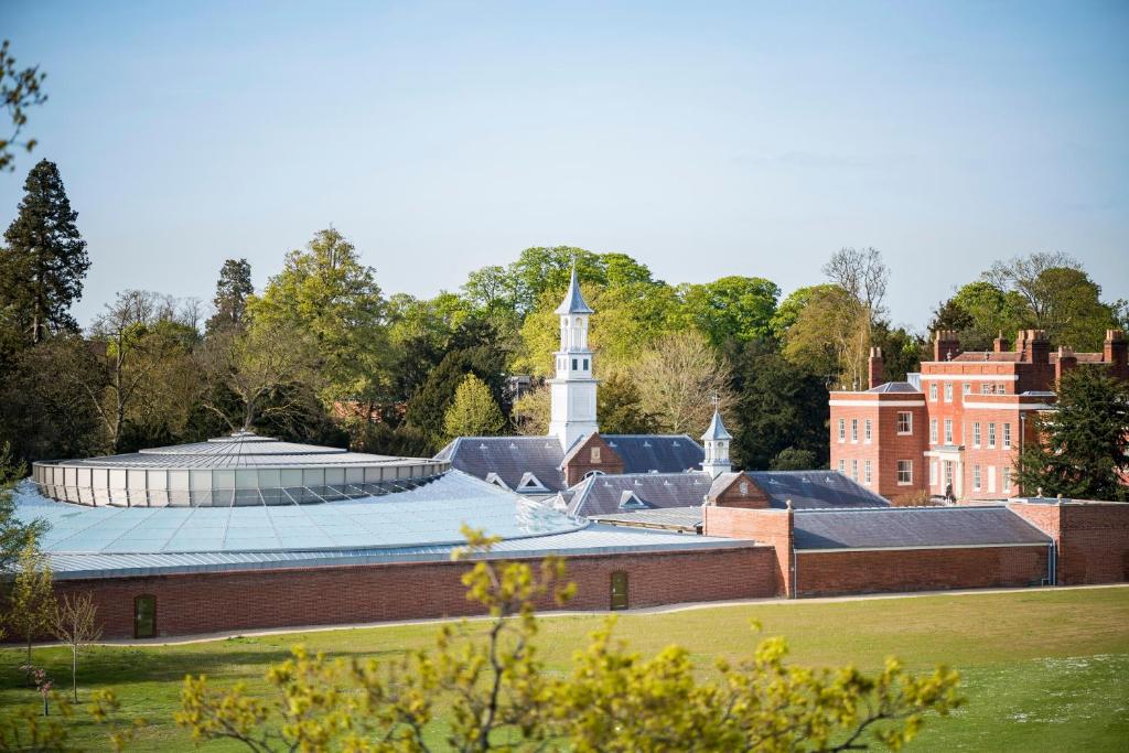 a view of the campus with a clock tower in the background at Hinxton Hall Conference Centre in Hinxton