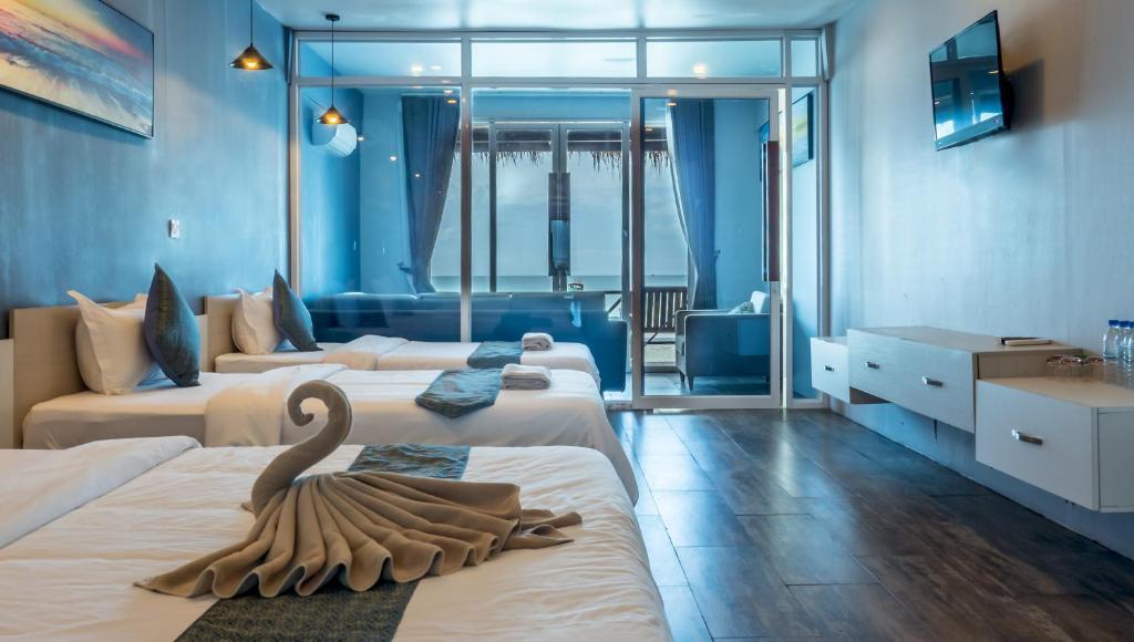 a hotel room with two beds with a swan on them at Sara Resort in Koh Rong Sanloem