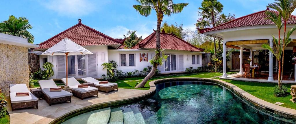 an image of a villa with a swimming pool at Hevea Villas in Seminyak