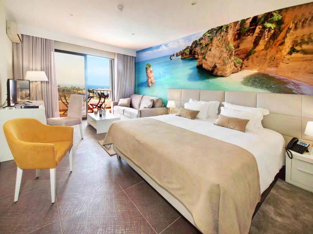 a hotel room with a large bed and a couch at Lagos Atlantic Hotel in Lagos