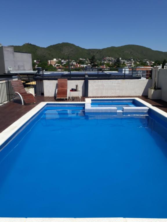 a swimming pool on the roof of a building at Departamento in Villa Carlos Paz