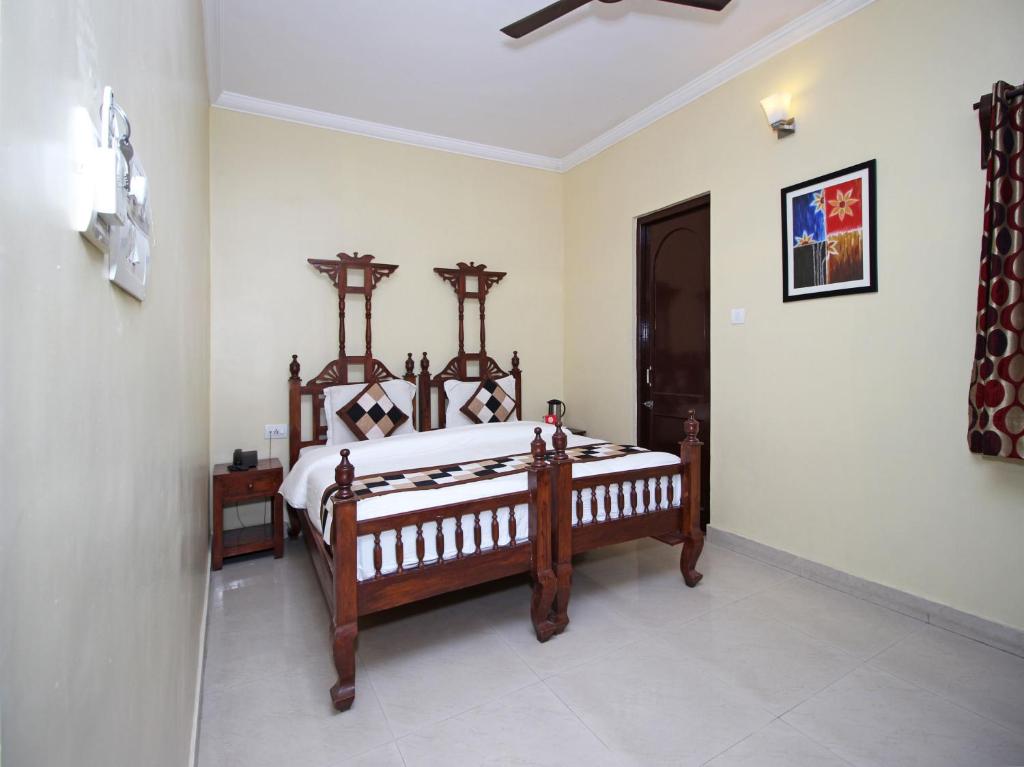 a bedroom with a large wooden bed in a room at Hotel Ajit Mansion in Jodhpur