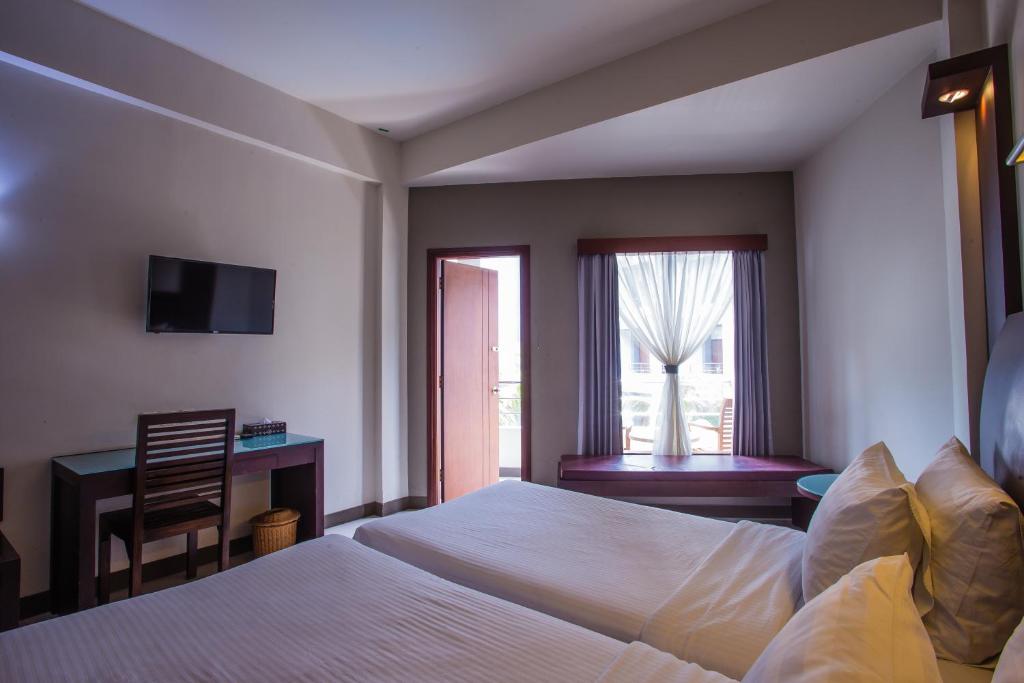 Postel nebo postele na pokoji v ubytování Lombok Garden Hotel