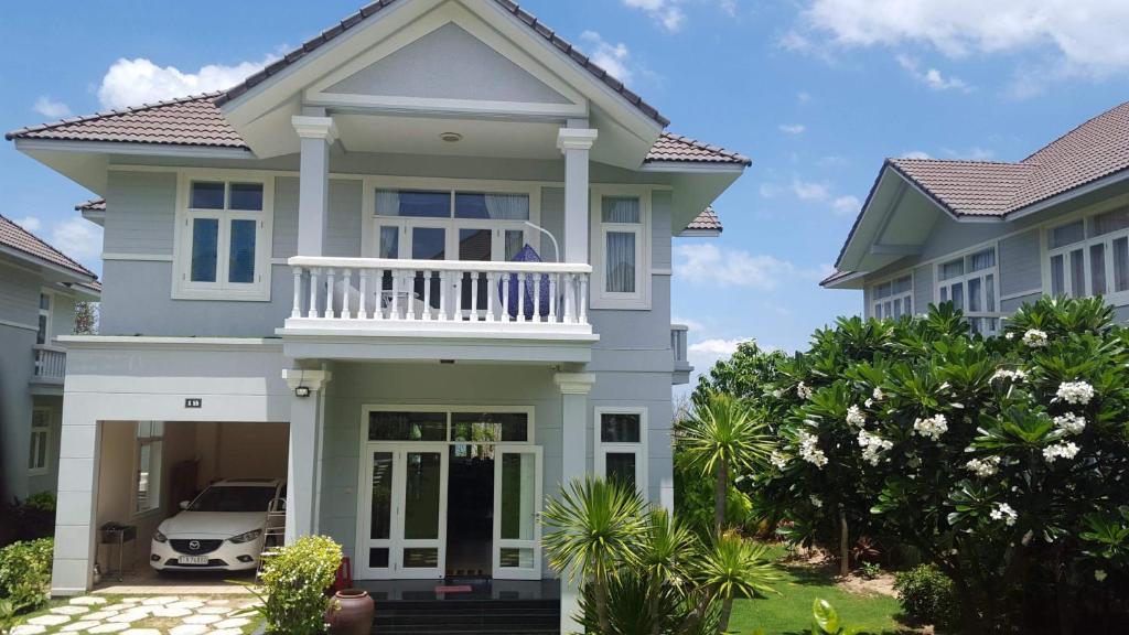 una casa con balcón y un coche en la entrada en Villa Mui Ne Phan Thiet, en Mui Ne