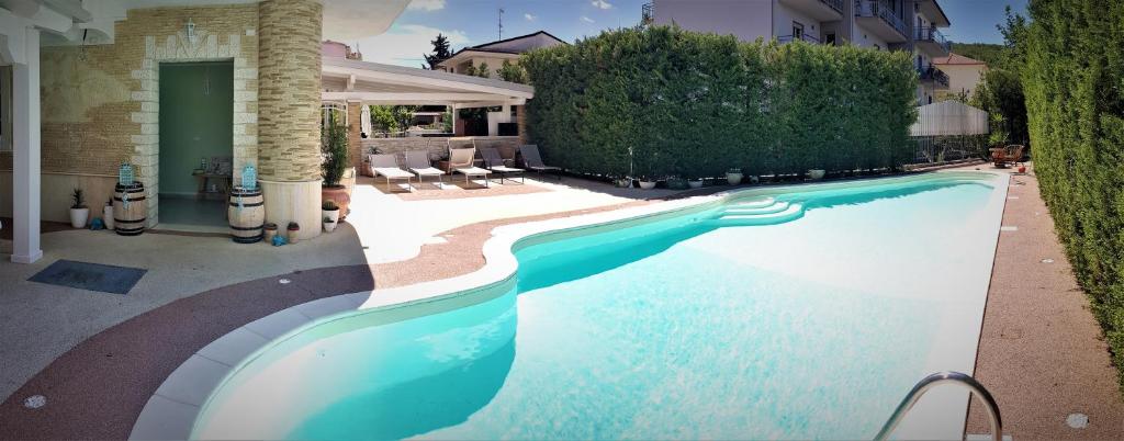 a swimming pool in front of a house at Glamour Bed & Breakfast in Montalto Uffugo