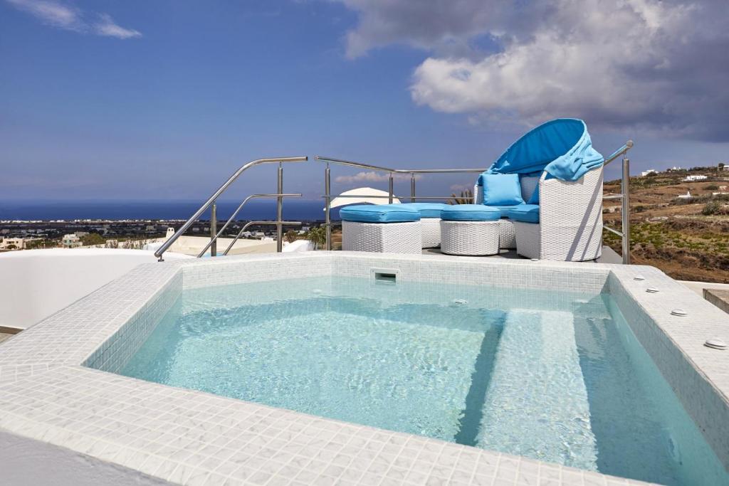 a large swimming pool with chairs and a swimming pool at Margo Houses in Vóthon
