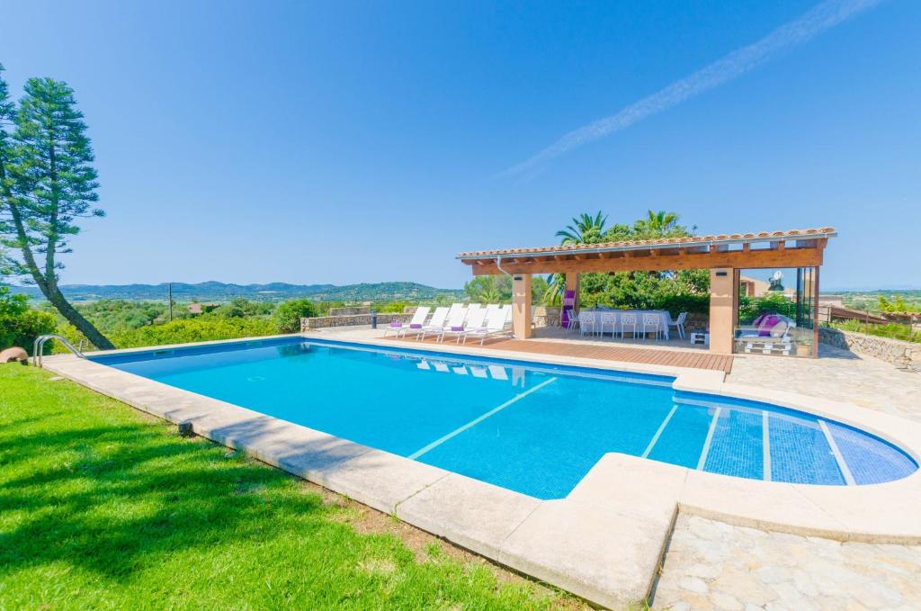 a swimming pool with a gazebo in a yard at Finca Can Setri in Sant Llorenç des Cardassar