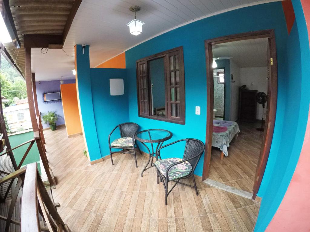 a room with a table and chairs in a room at Suítes Cantinho da Pedra in Abraão