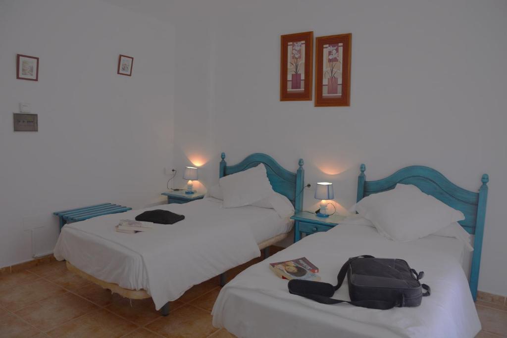 Postel nebo postele na pokoji v ubytování Hotel Al-Andalus