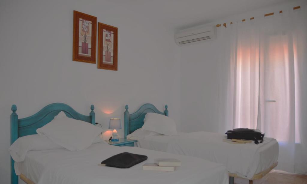Postel nebo postele na pokoji v ubytování Hotel Al-Andalus