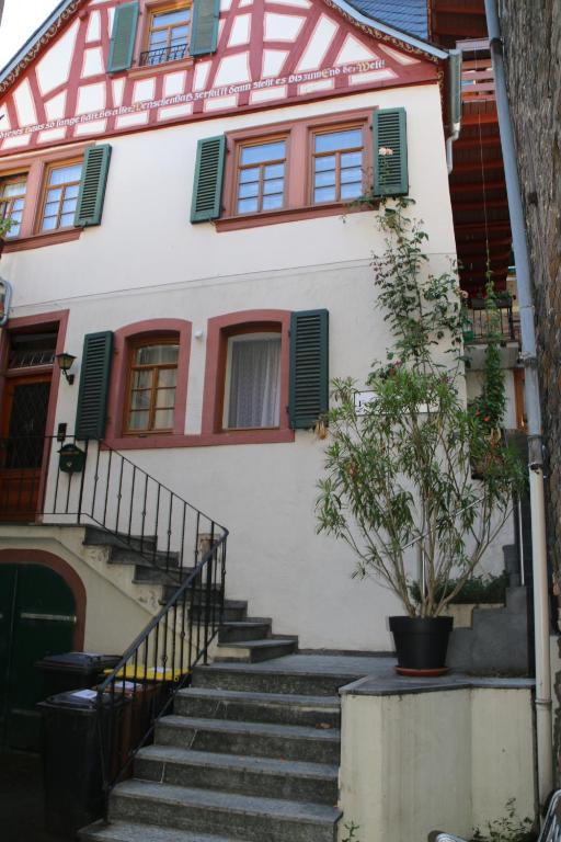 a white house with stairs in front of it at Ferienwohnung Feldhege in Bacharach