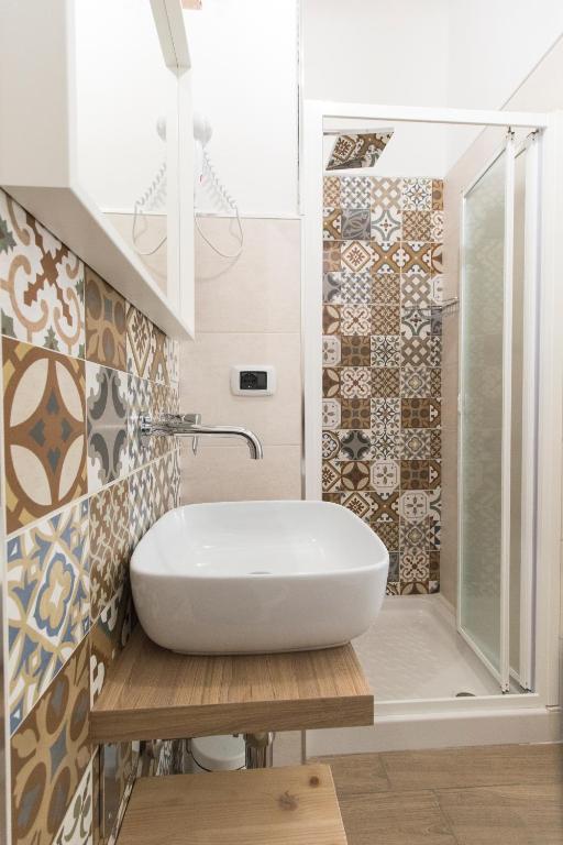 a bathroom with a white sink and a shower at Civico 1 in San Mauro Cilento