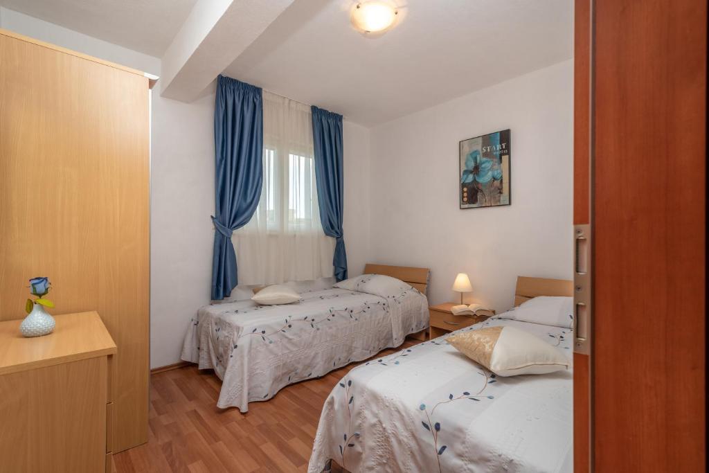 Postel nebo postele na pokoji v ubytování Apartments Villa Jelena