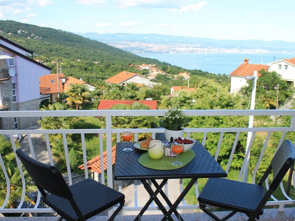 a table with a bowl of fruit on a balcony at Apartman Ruza 2 in Opric