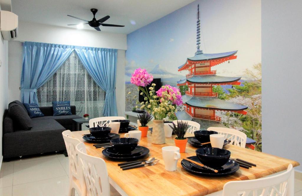 a dining room with a table with chairs and a room with a chinese building at H2H - Ohayō Ipoh Majestic Ipoh in Ipoh