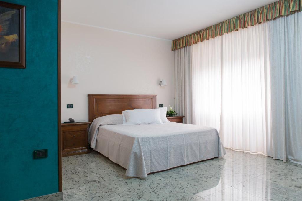Postel nebo postele na pokoji v ubytování Hotel Arcobaleno