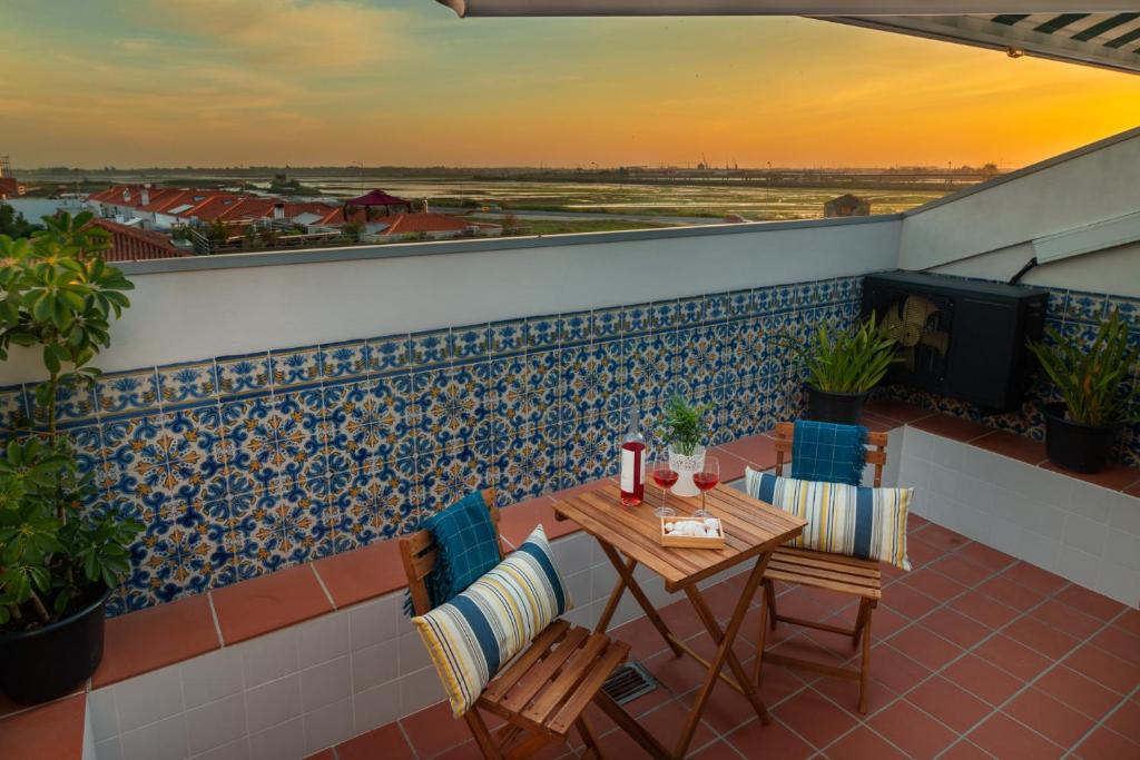 a patio with a table and chairs on a balcony at Feeltheland Ria Residence in Aveiro