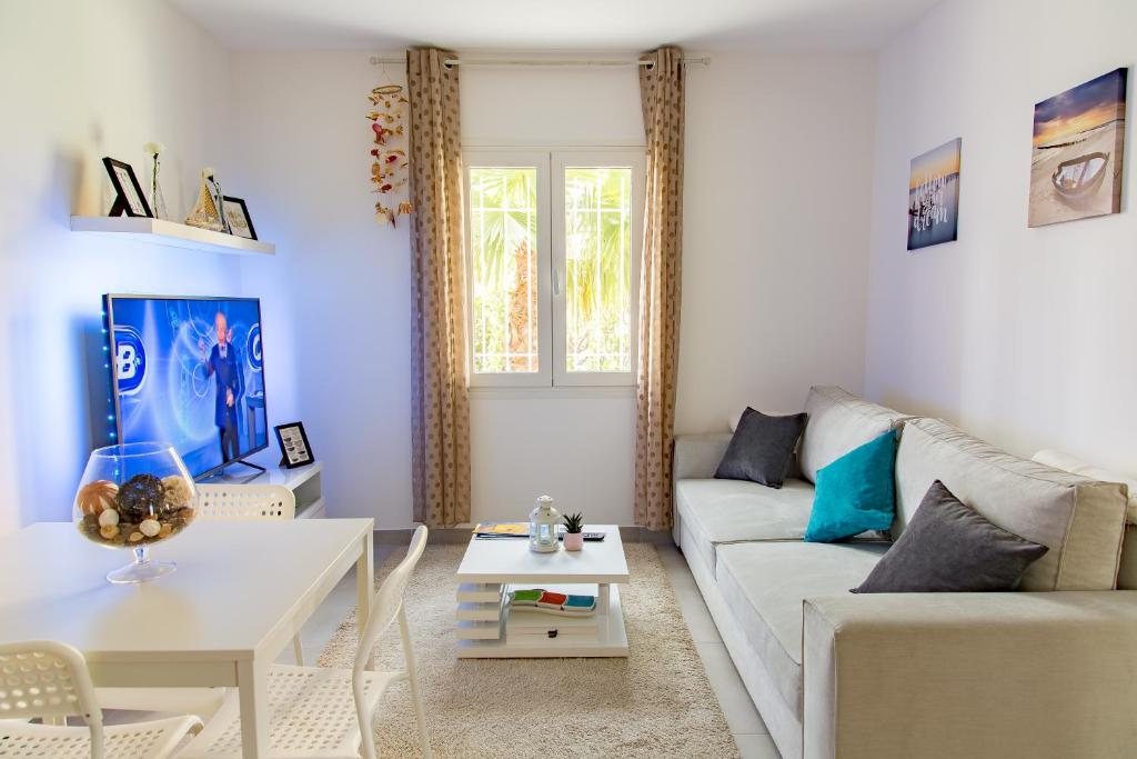 a living room with a white couch and a table at 552 AVENUE DE VALESCURE in Saint-Raphaël