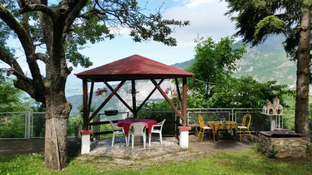 a gazebo with a table and chairs in a yard at Melnicani, Breathtaking view in Debar