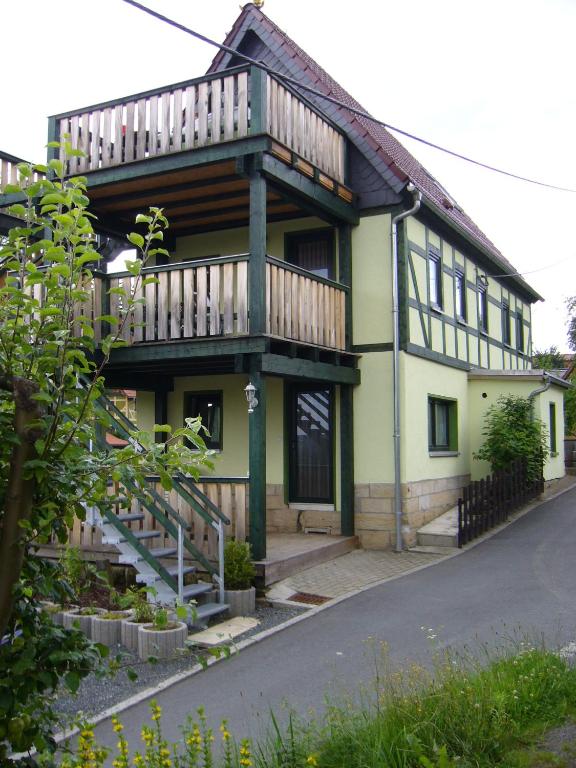 a house with a deck on the side of it at Ferienhaus Schrammsteinblick in Altendorf