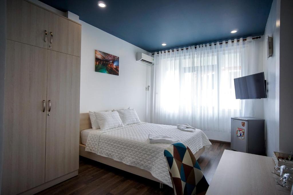 a small bedroom with a bed and a window at LeBlanc Saigon in Ho Chi Minh City