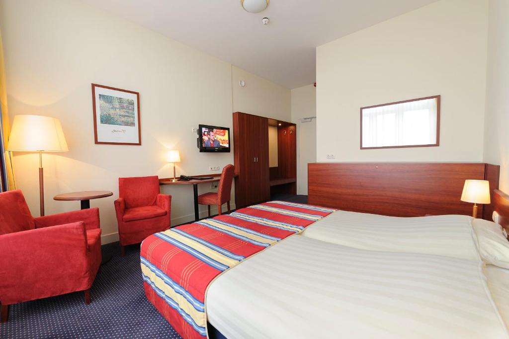 Postel nebo postele na pokoji v ubytování Boulevard Hotel Scheveningen