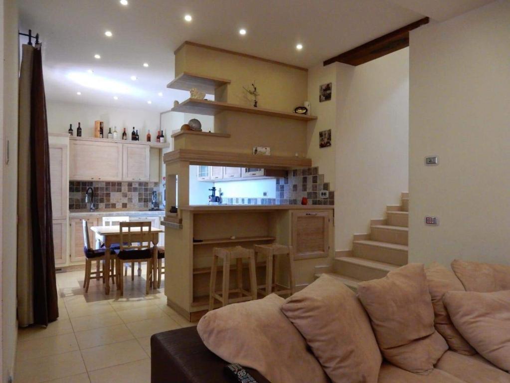 a living room with a couch and a kitchen at Villa Angelinas in Monte San Savino