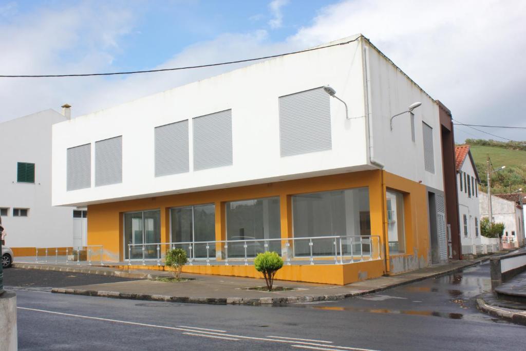 un edificio blanco y amarillo al lado de una calle en A Casa Sousa, en Ginetes