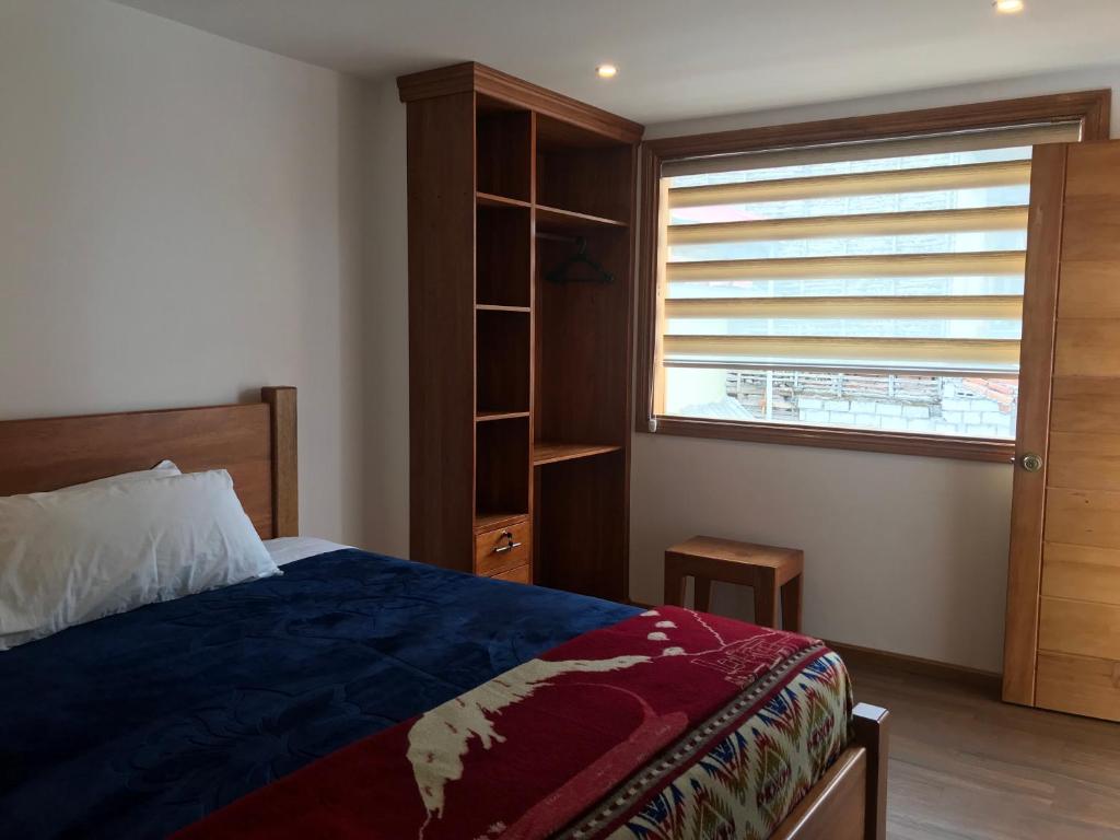 Postel nebo postele na pokoji v ubytování Community Hostel Alausi