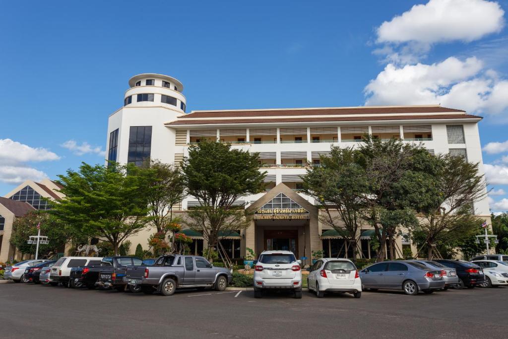 a parking lot in front of a building with cars parked at Surin Majestic Hotel in Surin