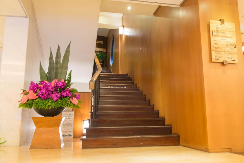 a staircase in a hospital with a potted plant at Beitou Sweet Me Hot Spring Resort in Taipei